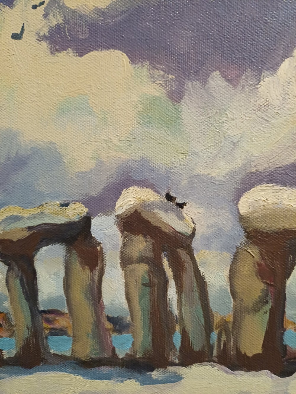 A framed original oil painting depicting the Heel Stone and Stonehenge covered in snow under a cloudy sky with two crows in the foreground. View IX