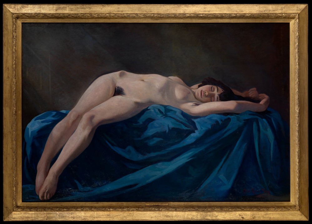 An oil painting on canvas depicting a reclining female nude figure resting upon draped vibrant blue cloth set within a moulded gilt frame.