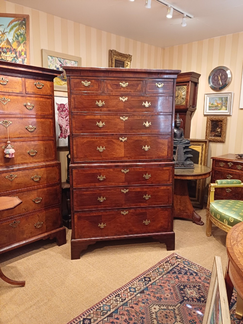 An early eighteenth-century walnut chest on chest featuring crossbanded drawers, brass handles, and bracket feet. View XII