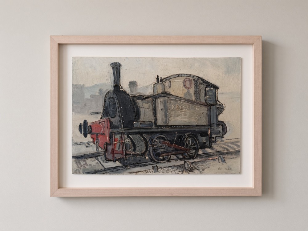 An original oil painting on board depicting a dark grey and red side tank steam locomotive sitting on railway tracks, presented in a light wooden frame with a wide mount.