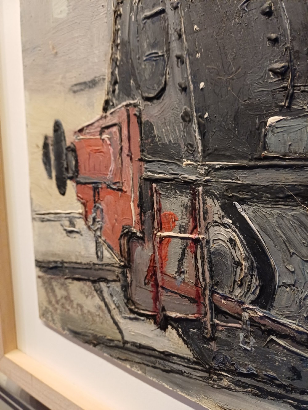 An original oil painting on board depicting a dark grey and red side tank steam locomotive sitting on railway tracks, presented in a light wooden frame with a wide mount. View III