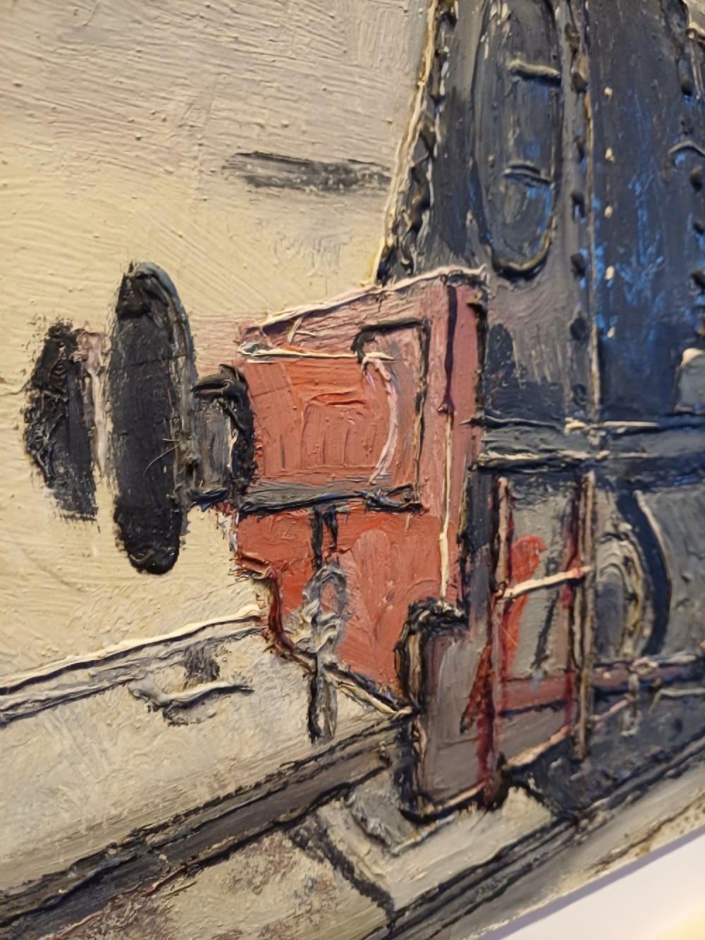 An original oil painting on board depicting a dark grey and red side tank steam locomotive sitting on railway tracks, presented in a light wooden frame with a wide mount. View IX