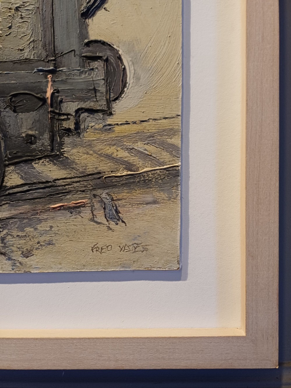 An original oil painting on board depicting a dark grey and red side tank steam locomotive sitting on railway tracks, presented in a light wooden frame with a wide mount. View XIV