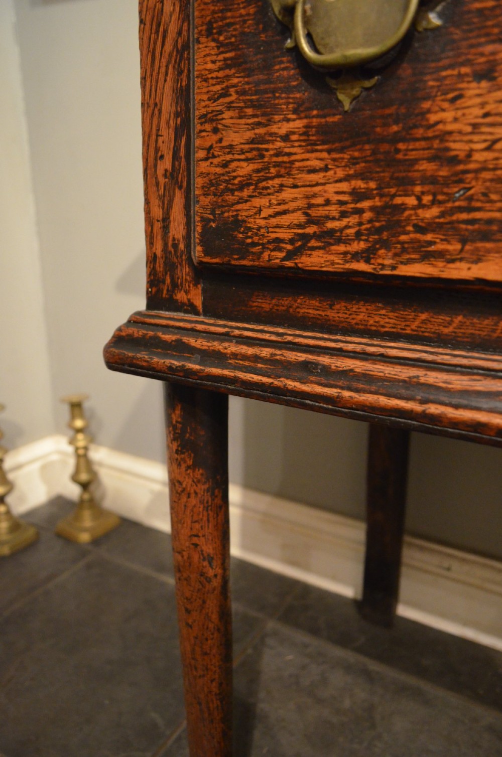 An 18th-century George III oak dresser base featuring three drawers with decorative brass handles and supported on slender legs with pad feet. View VI