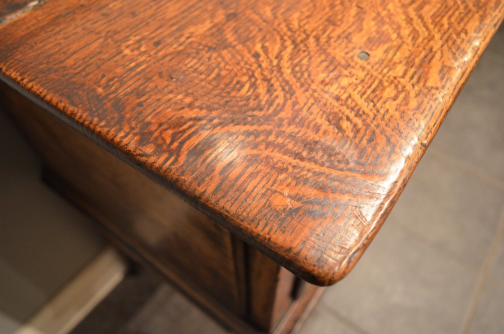 An 18th-century George III oak dresser base featuring three drawers with decorative brass handles and supported on slender legs with pad feet. View IX