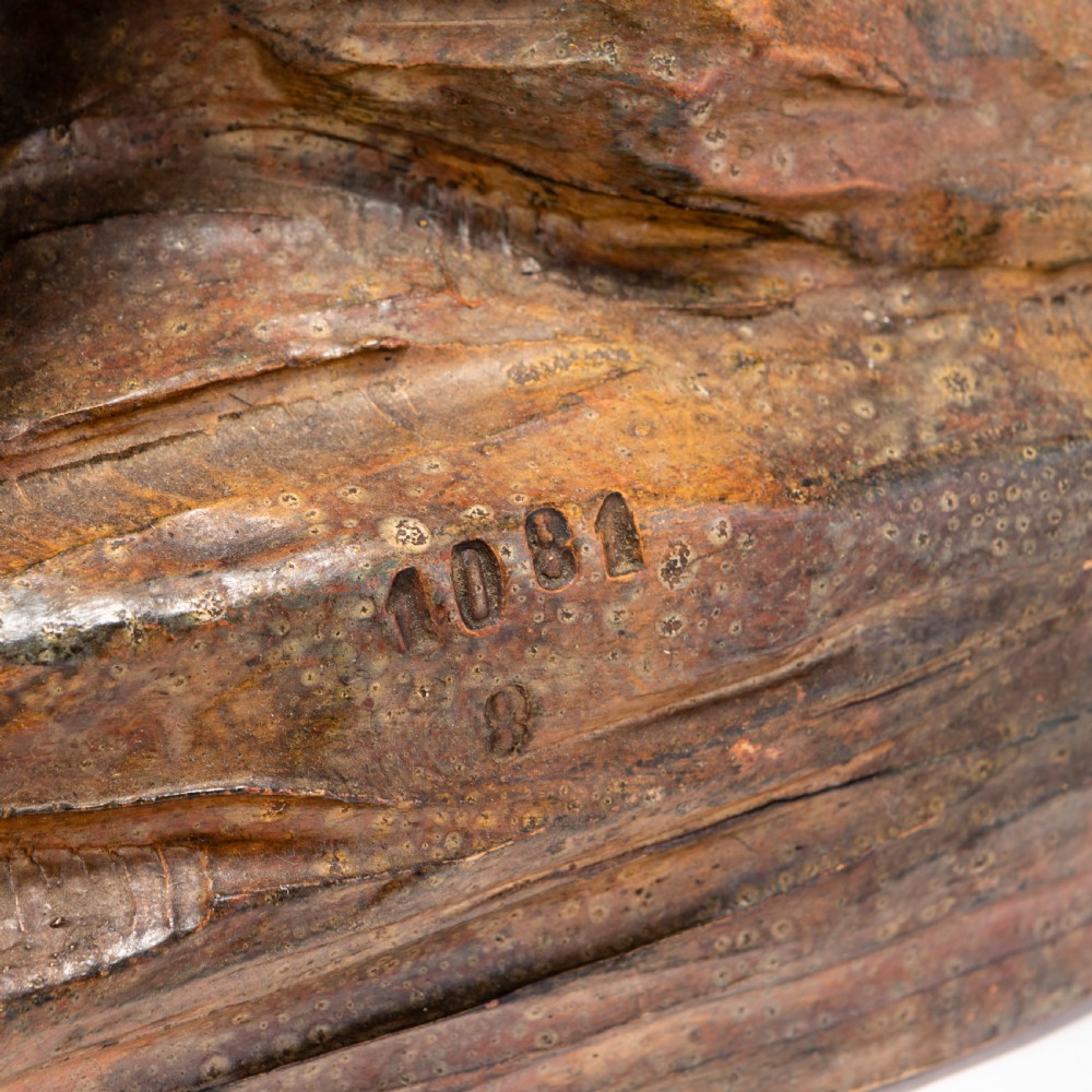 A dark brown patinated ceramic sculpture depicting a roaring tiger poised on a rocky base in the Art Deco style. View VI