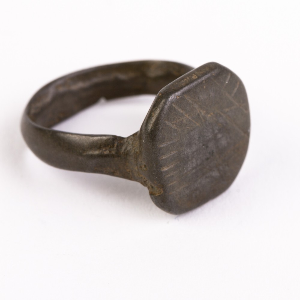 A dark patinated bronze signet ring featuring an octagonal bezel with faint geometric hand-engraved markings. View II