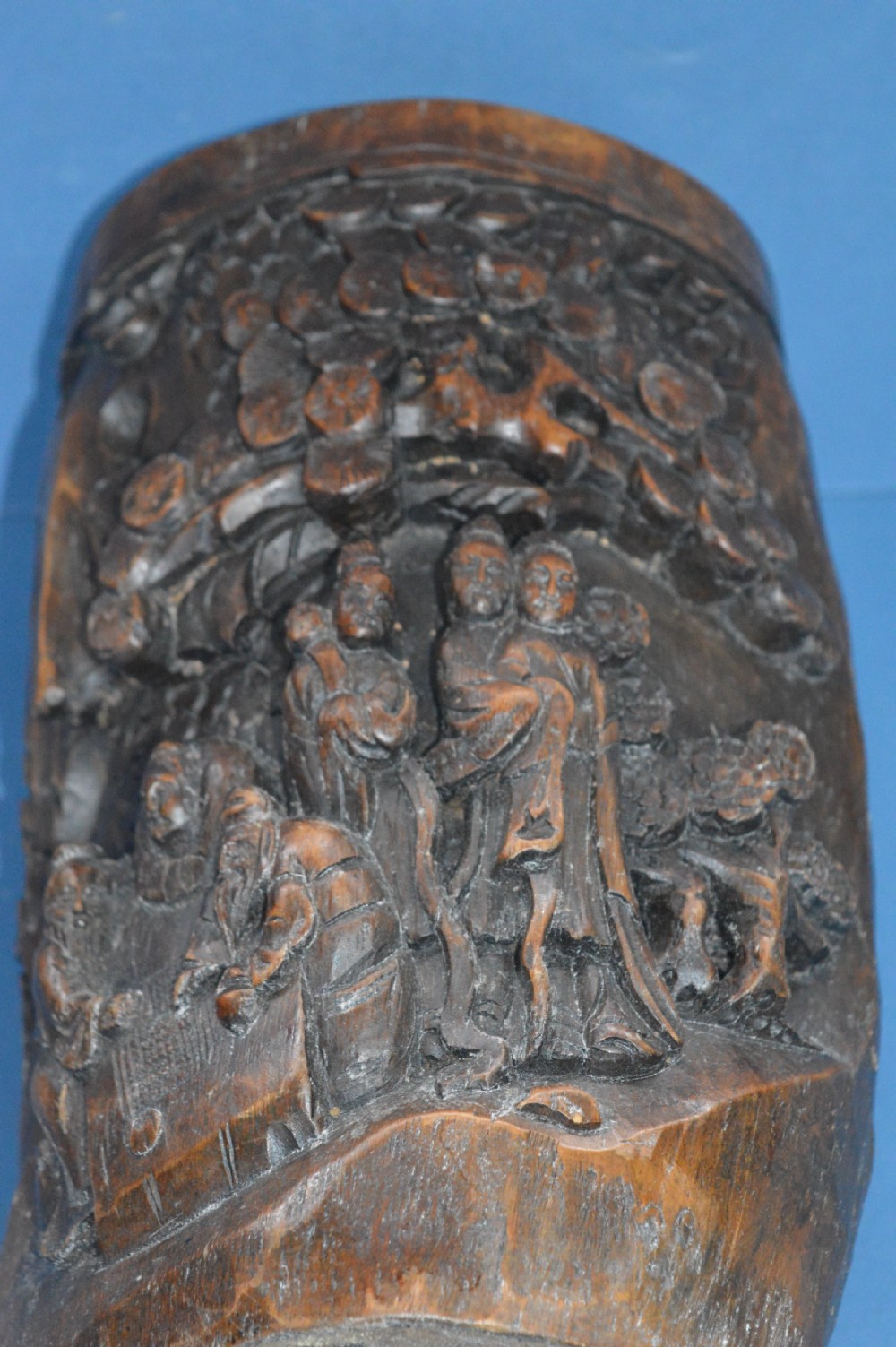 A late nineteenth-century hand-carved dark brown Chinese bamboo brush pot depicting figures and pine trees in high relief. View VIII