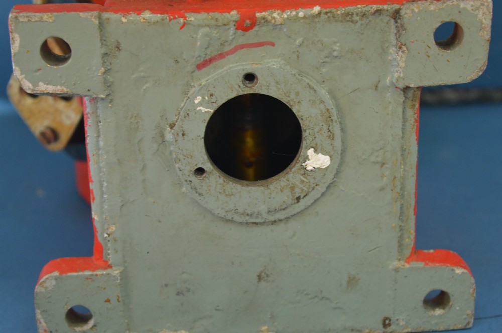 A mid-20th-century red and black painted metal ship engine order telegraph featuring a circular dial with ahead and astern markings behind glass and a four-spoke control wheel. View X