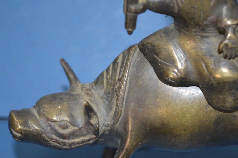 A late 19th-century cast bronze censer depicting a man dressed in robes seated astride a horned ox or water buffalo. View III