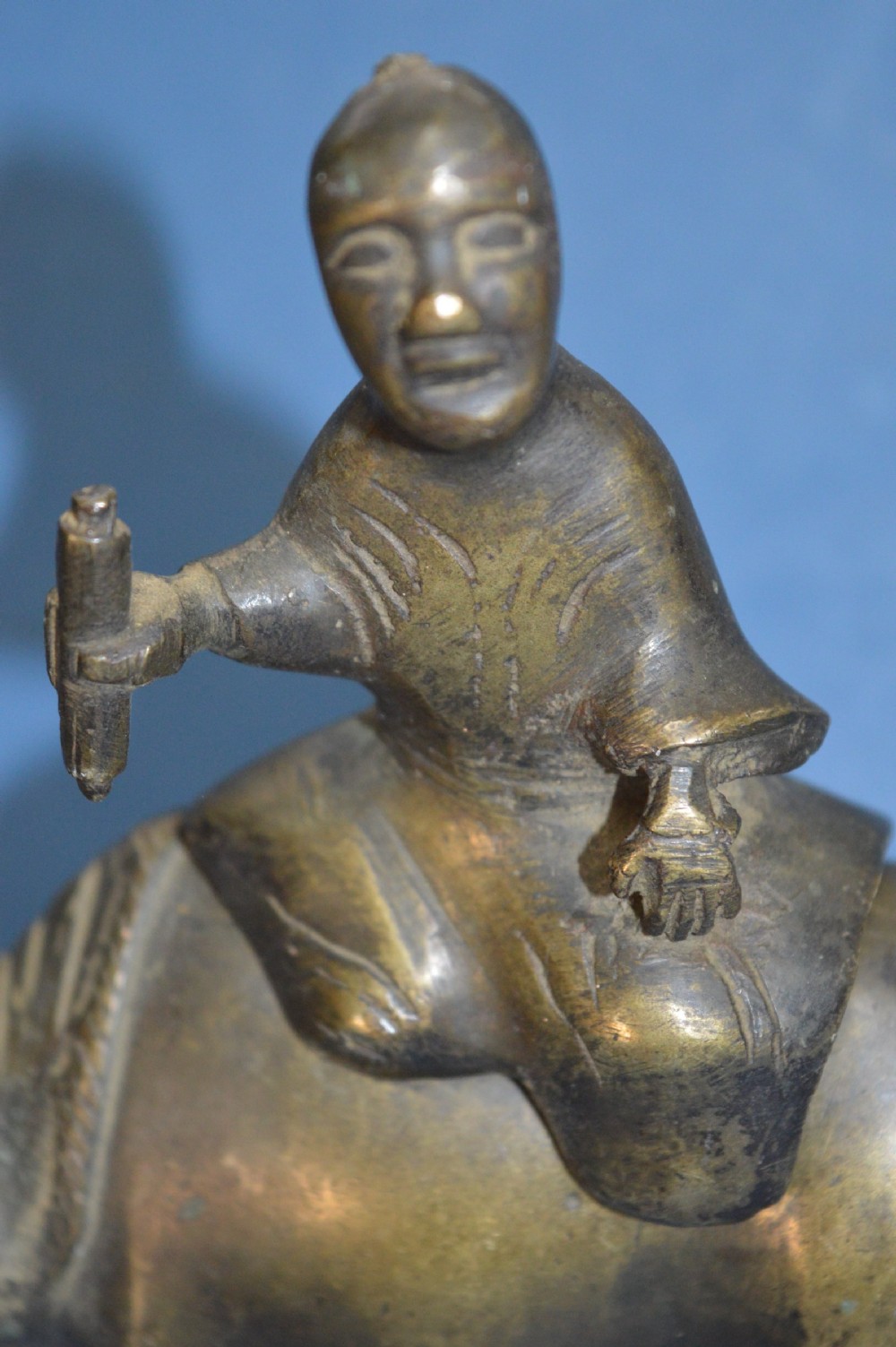 A late 19th-century cast bronze censer depicting a man dressed in robes seated astride a horned ox or water buffalo. View IV