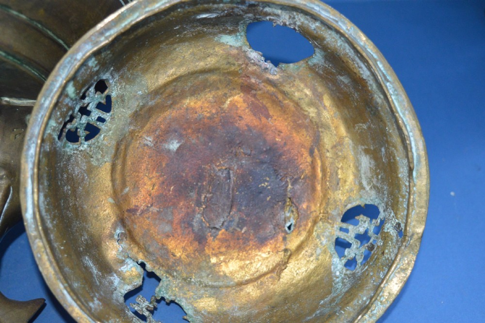 A heavy Chinese bronze lidded censer featuring a foo dog lid finial, pierced cover, double beast side handles, and three tripod feet. View XIII
