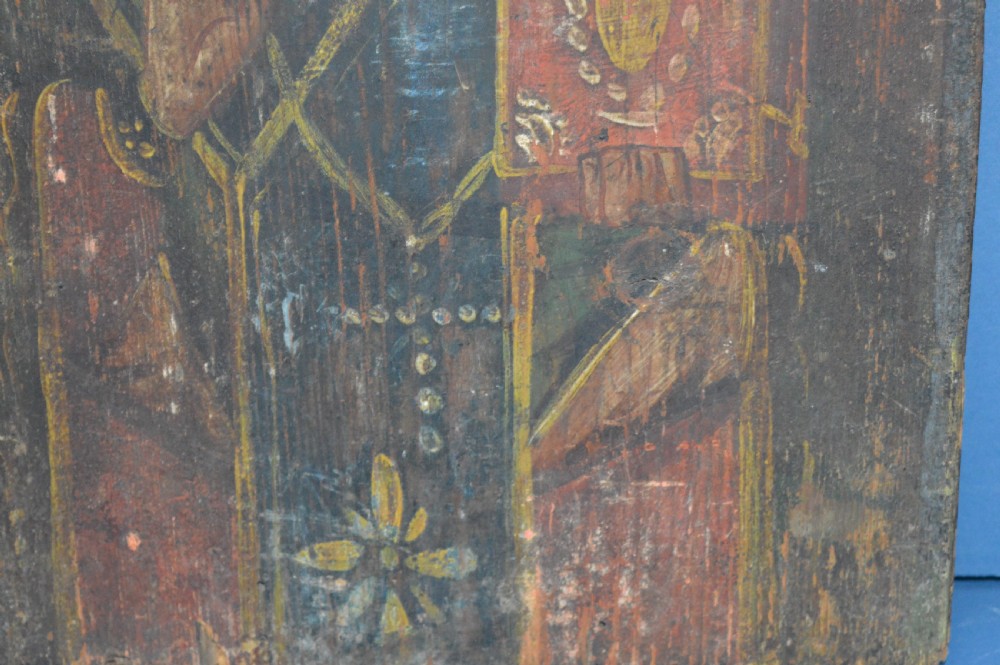 An antique hand-painted Russian wooden icon depicting a religious figure with a halo and holding a scripture book. View IV