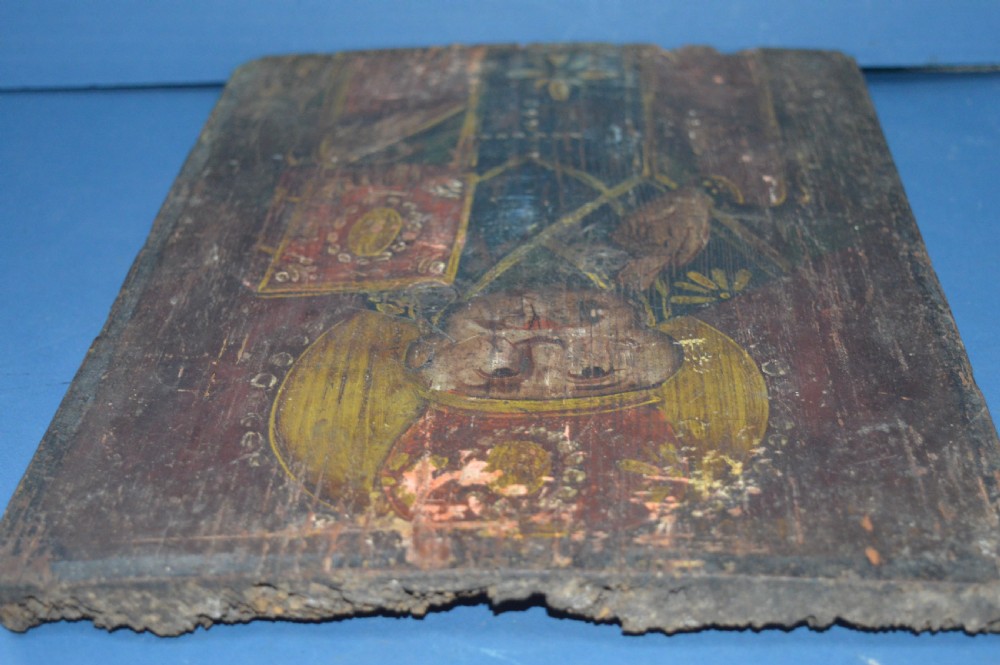 An antique hand-painted Russian wooden icon depicting a religious figure with a halo and holding a scripture book. View VII
