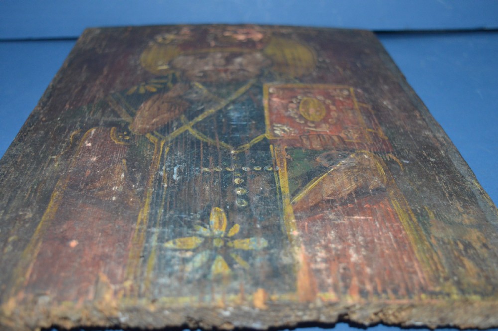 An antique hand-painted Russian wooden icon depicting a religious figure with a halo and holding a scripture book. View IX