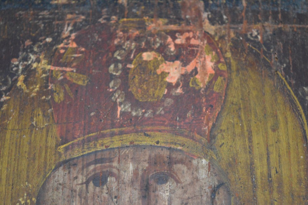 An antique hand-painted Russian wooden icon depicting a religious figure with a halo and holding a scripture book. View X