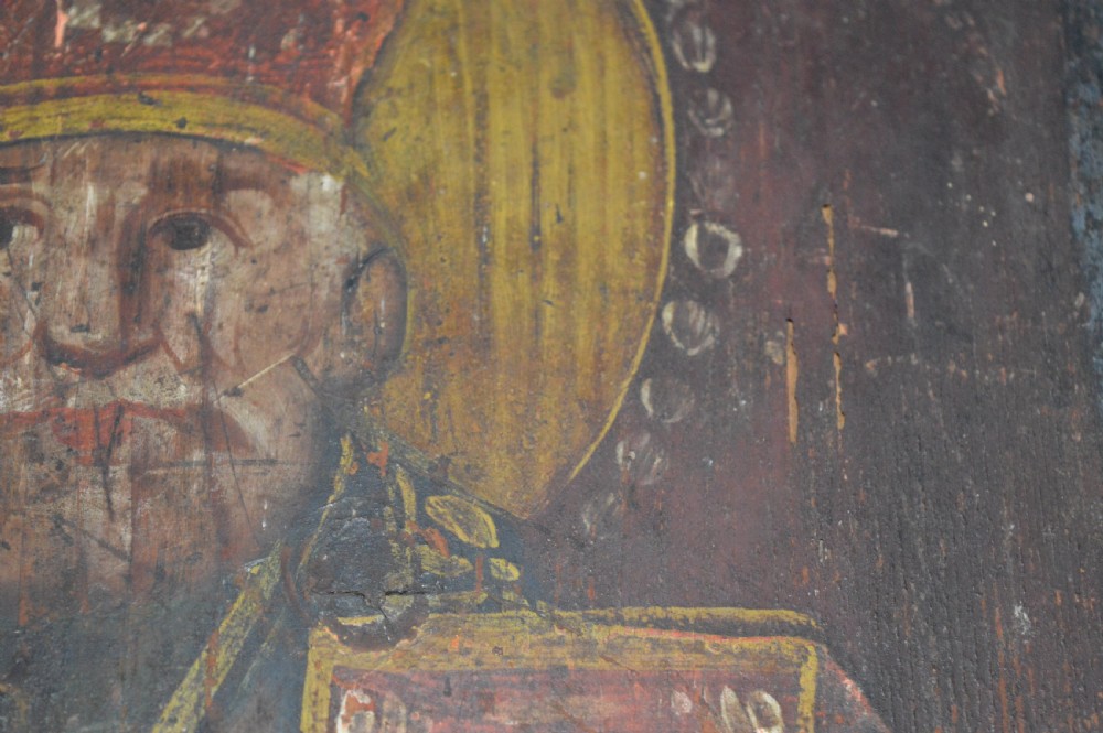 An antique hand-painted Russian wooden icon depicting a religious figure with a halo and holding a scripture book. View XI