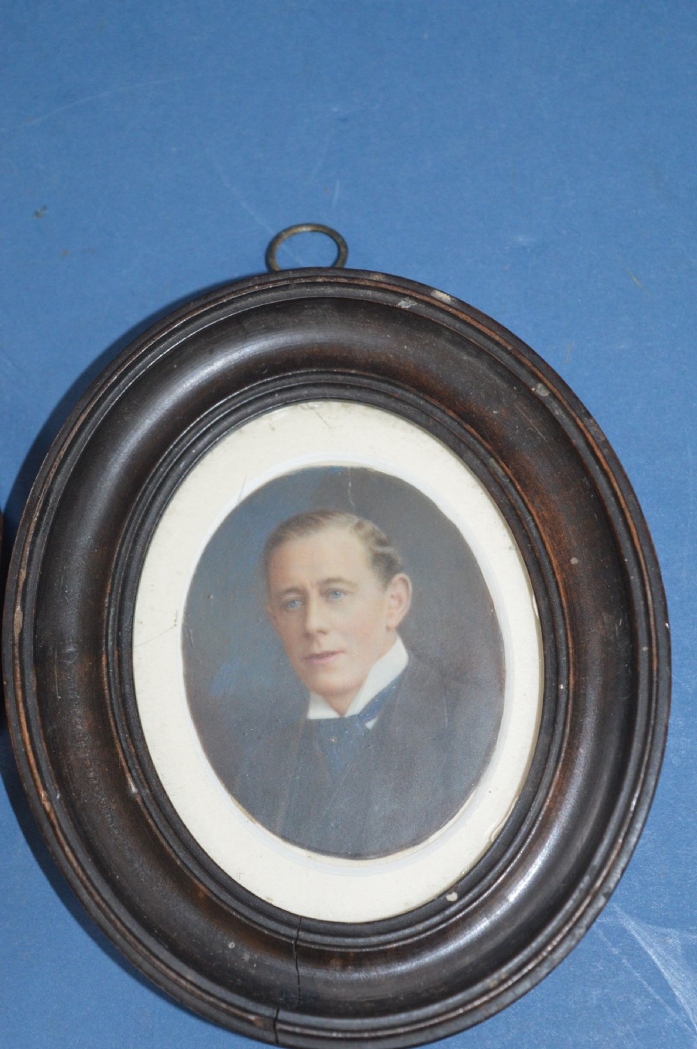 A pair of late 19th-century oval miniature watercolour portraits depicting a woman and a man in matching moulded wooden frames. View II