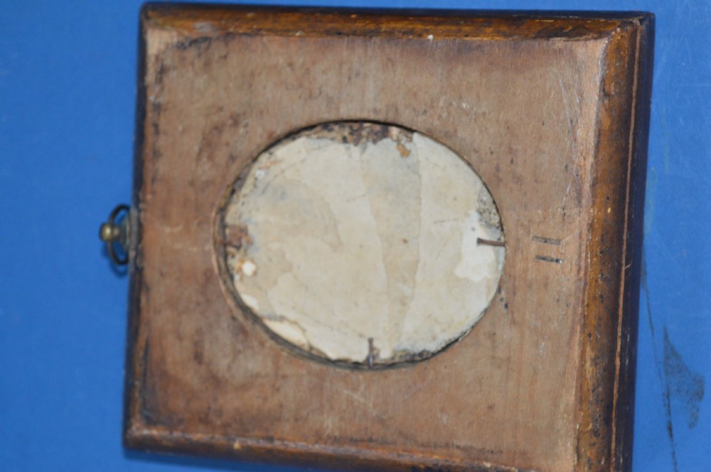 Two Georgian portrait miniatures from circa 1800, one set in a rectangular giltwood frame and the other in a velvet-lined burgundy leather folding case. View VI