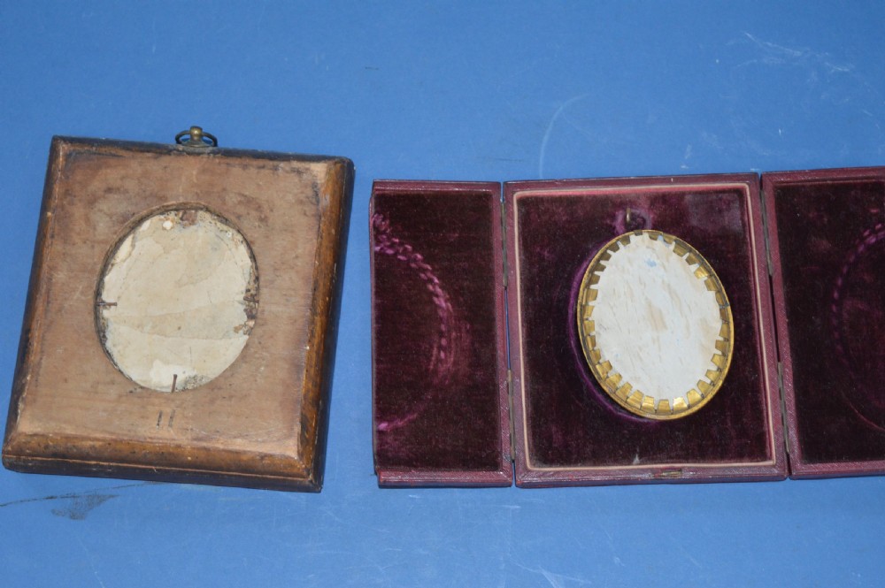 Two Georgian portrait miniatures from circa 1800, one set in a rectangular giltwood frame and the other in a velvet-lined burgundy leather folding case. View VII