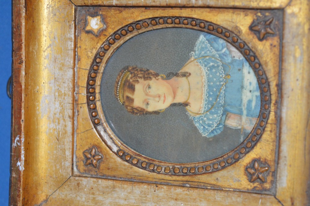 Two Georgian portrait miniatures from circa 1800, one set in a rectangular giltwood frame and the other in a velvet-lined burgundy leather folding case. View XI