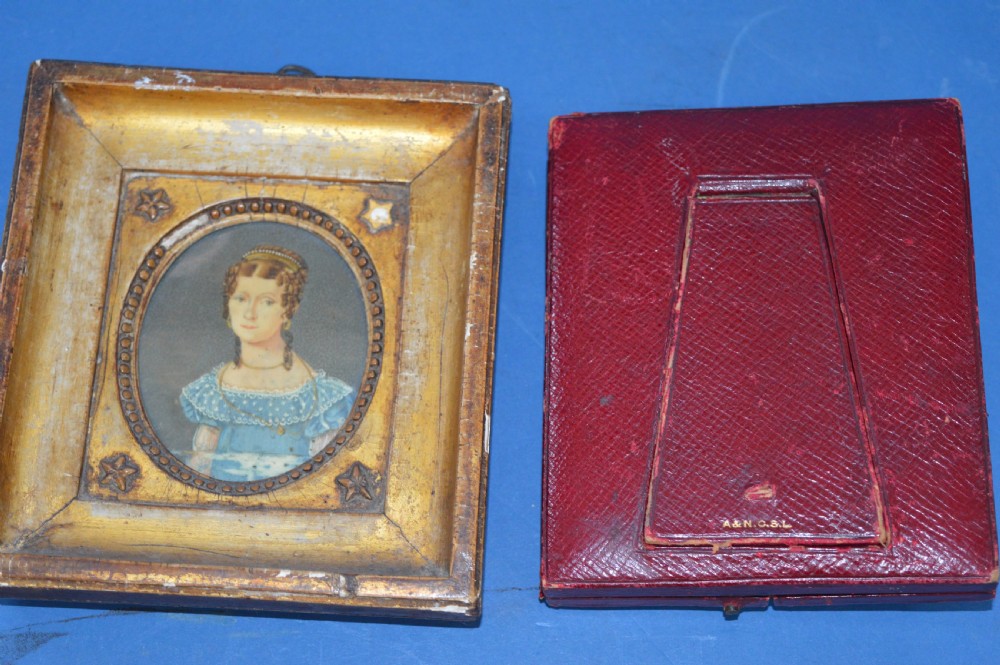 Two Georgian portrait miniatures from circa 1800, one set in a rectangular giltwood frame and the other in a velvet-lined burgundy leather folding case. View XII