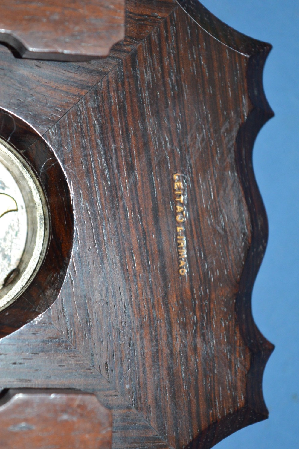 An Art Nouveau shaped wooden mantel clock clad in ornate chased silver relief with foliage motifs surrounding a central white enamel dial. View VI