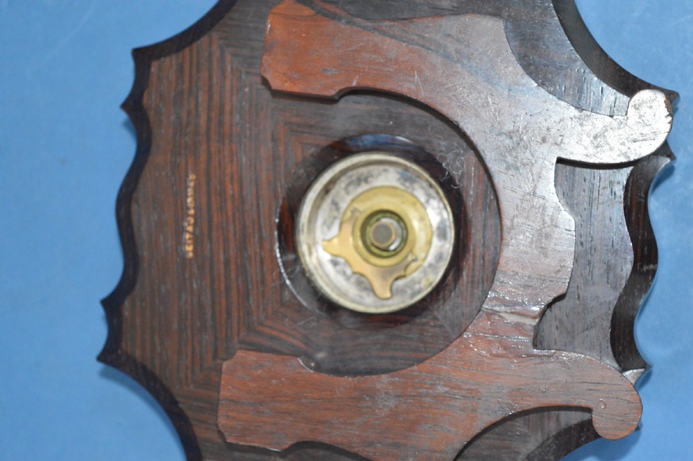 An Art Nouveau shaped wooden mantel clock clad in ornate chased silver relief with foliage motifs surrounding a central white enamel dial. View XI