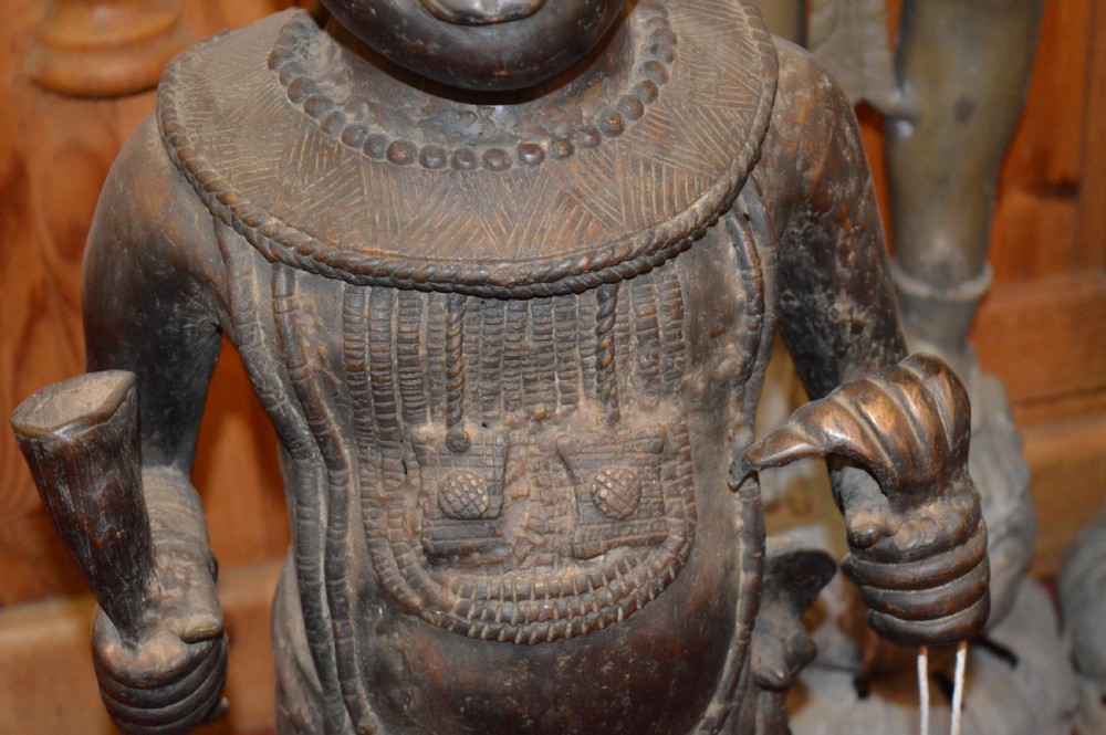 A standing cast bronze West African warrior figure with ceremonial headwear, detailed chest ornamentation, and traditional waist garment. View VIII