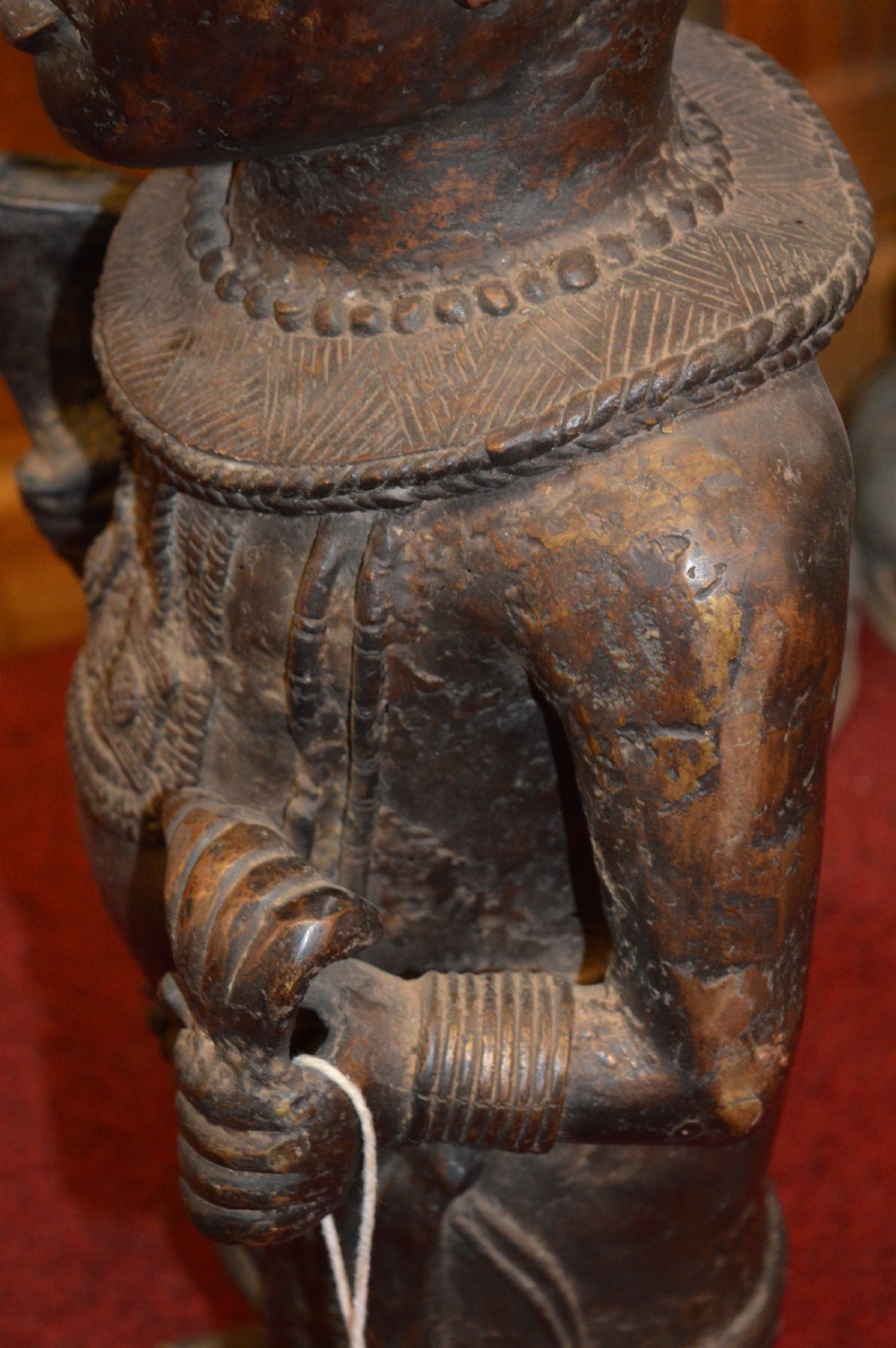 A standing cast bronze West African warrior figure with ceremonial headwear, detailed chest ornamentation, and traditional waist garment. View XIV
