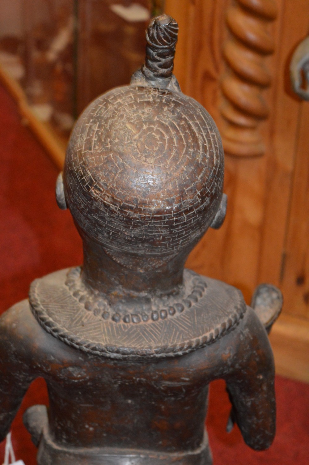 A standing cast bronze West African warrior figure with ceremonial headwear, detailed chest ornamentation, and traditional waist garment. View XV