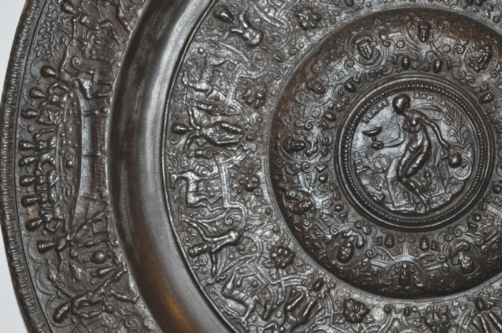 A large circular dark bronze charger featuring concentric bands of classical relief figures surrounding a central classical medallion. View III