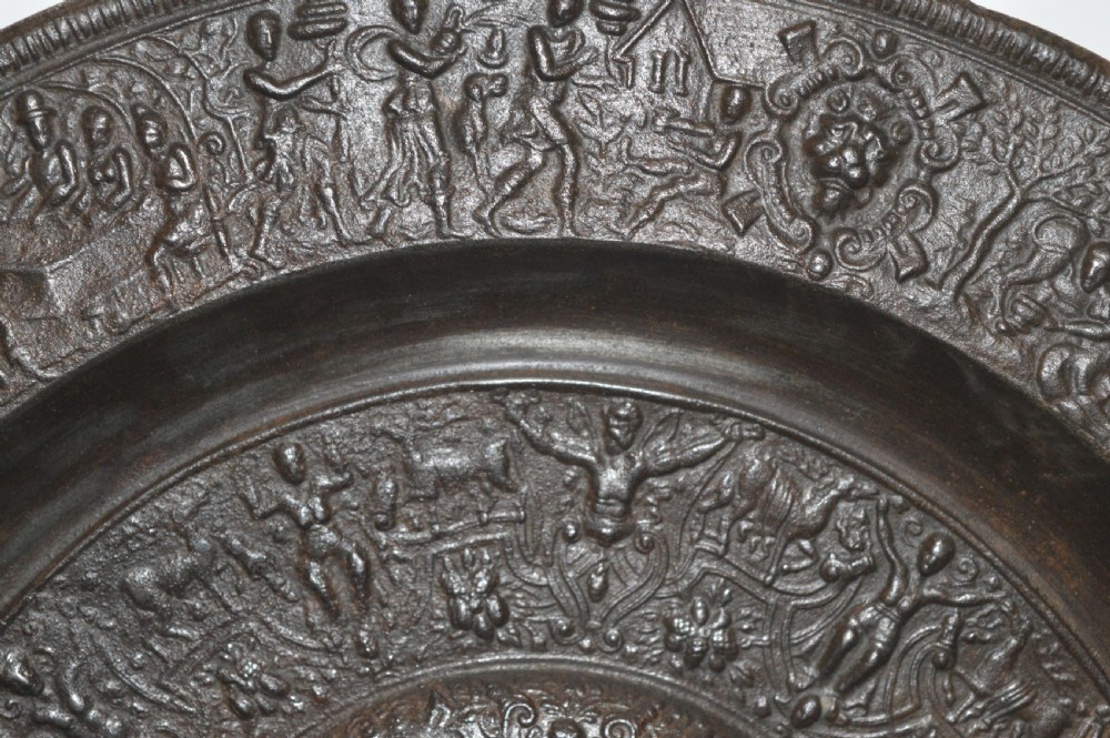 A large circular dark bronze charger featuring concentric bands of classical relief figures surrounding a central classical medallion. View VII