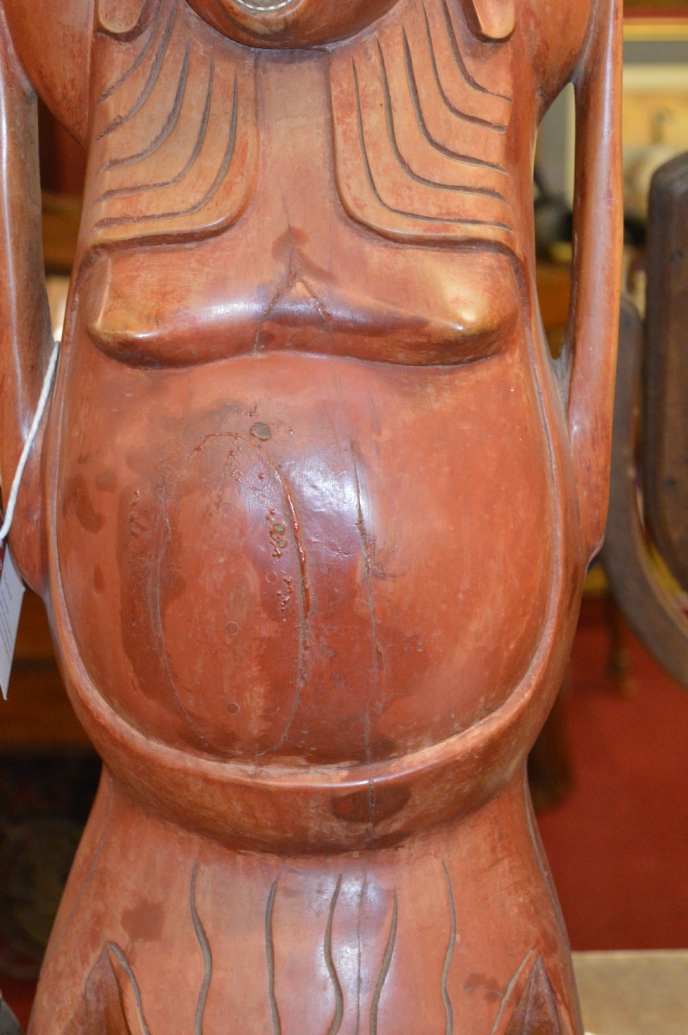 A nineteenth-century carved wooden statue depicting a laughing Buddha figure standing with arms raised above its head. View III