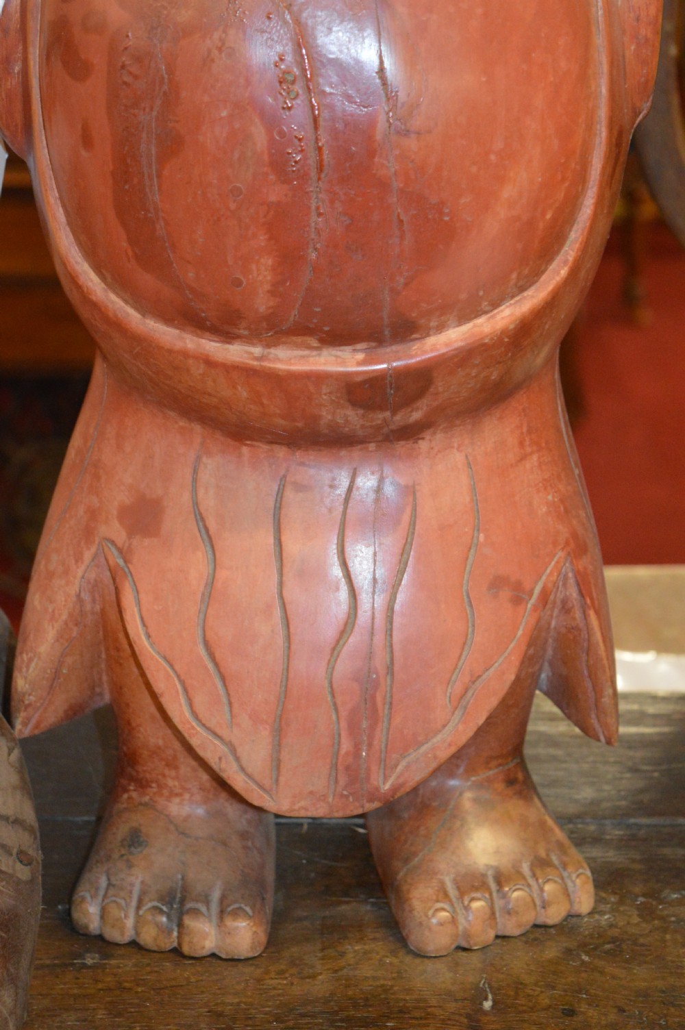 A nineteenth-century carved wooden statue depicting a laughing Buddha figure standing with arms raised above its head. View IV
