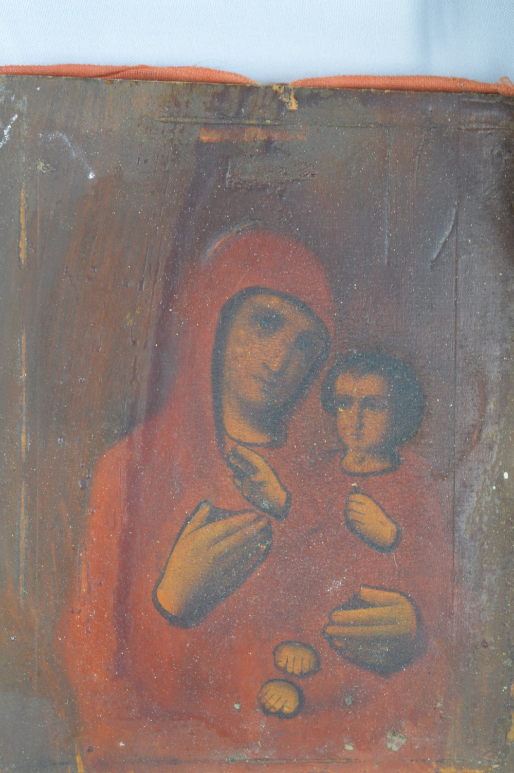 An early 20th-century Russian Orthodox icon depicting the Virgin Mary and Christ Child inside a carved, gilded wooden frame. View IV