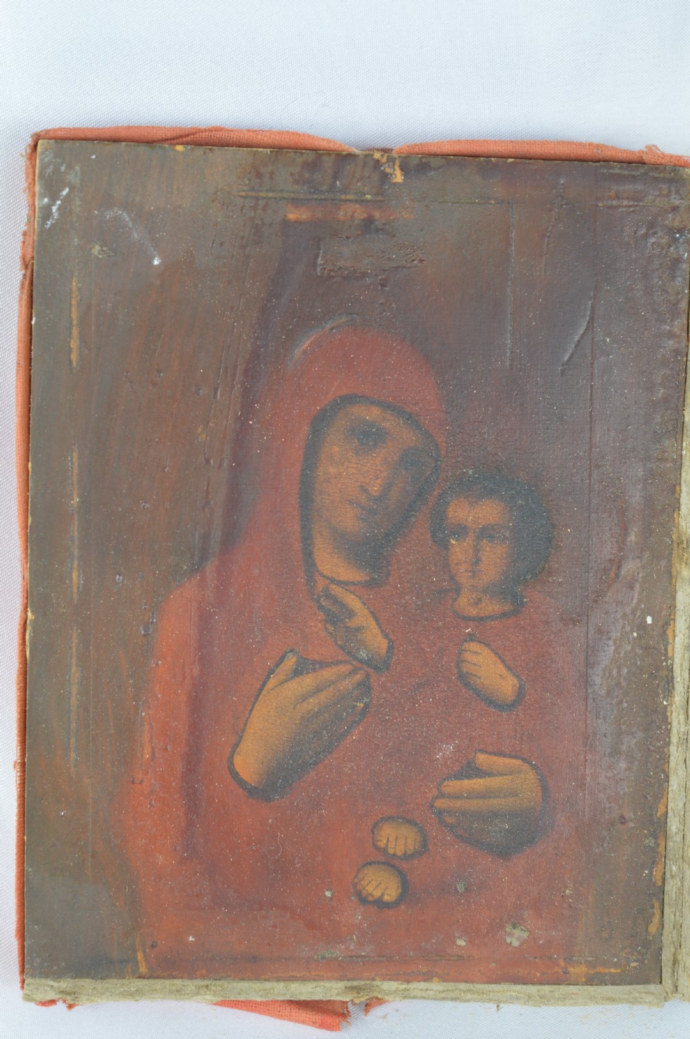 An early 20th-century Russian Orthodox icon depicting the Virgin Mary and Christ Child inside a carved, gilded wooden frame. View X