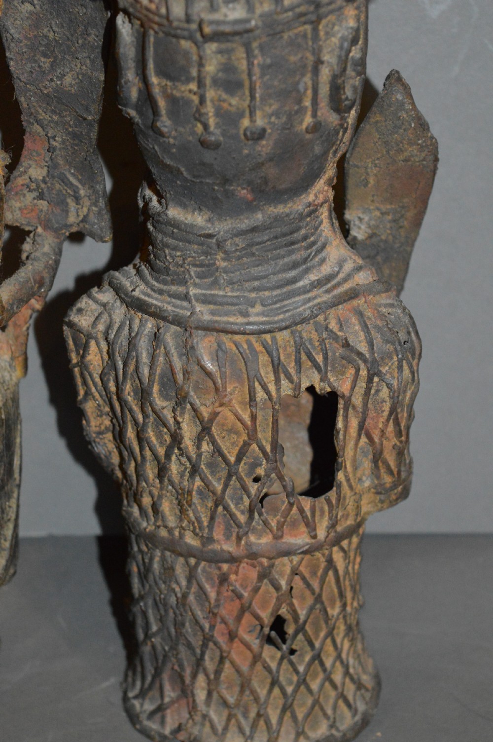 A pair of cast bronze West African warrior statues featuring textured headpieces, patterned garments, and held spears. View VII