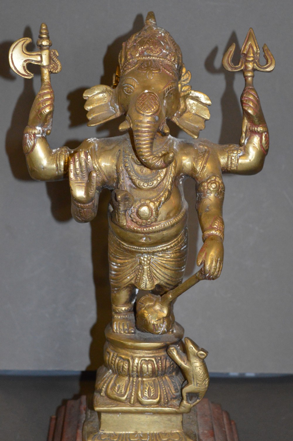 A late 19th-century cast bronze standing Lord Ganesha statue mounted on a lotus pedestal with a small rodent figure at the base.