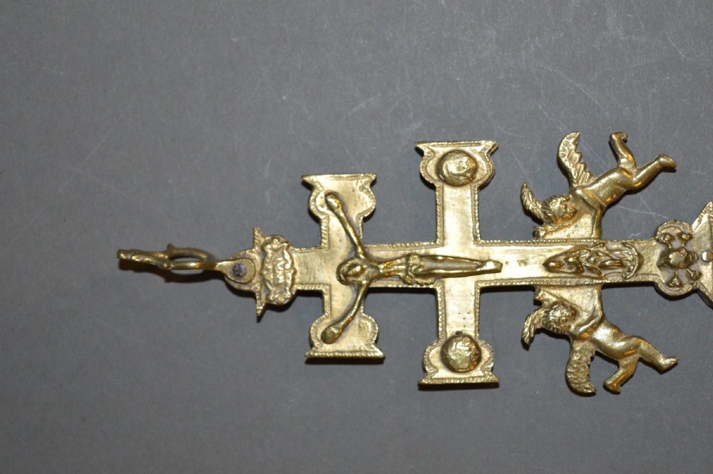 A set of three late nineteenth-century Spanish brass devotional items, including two Caravaca double-barred crosses with angel figures and one central hinged miniature shrine. View III