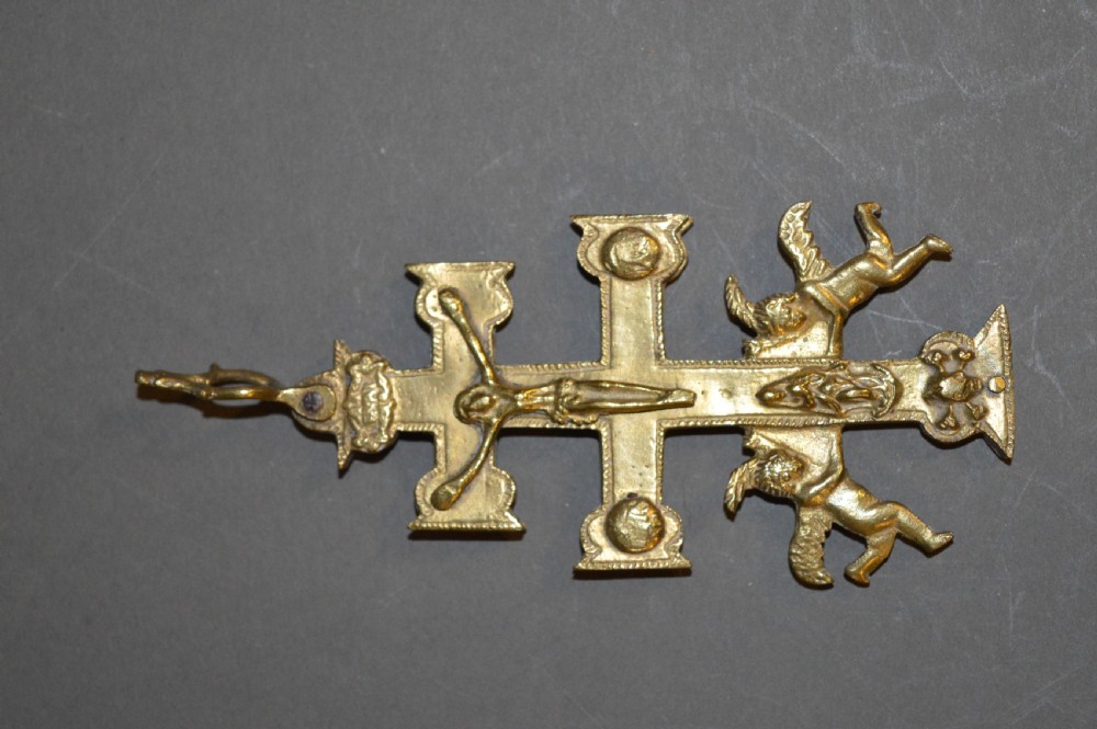 A set of three late nineteenth-century Spanish brass devotional items, including two Caravaca double-barred crosses with angel figures and one central hinged miniature shrine. View IV