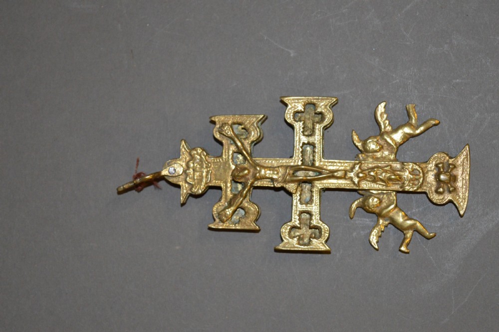A set of three late nineteenth-century Spanish brass devotional items, including two Caravaca double-barred crosses with angel figures and one central hinged miniature shrine. View VI