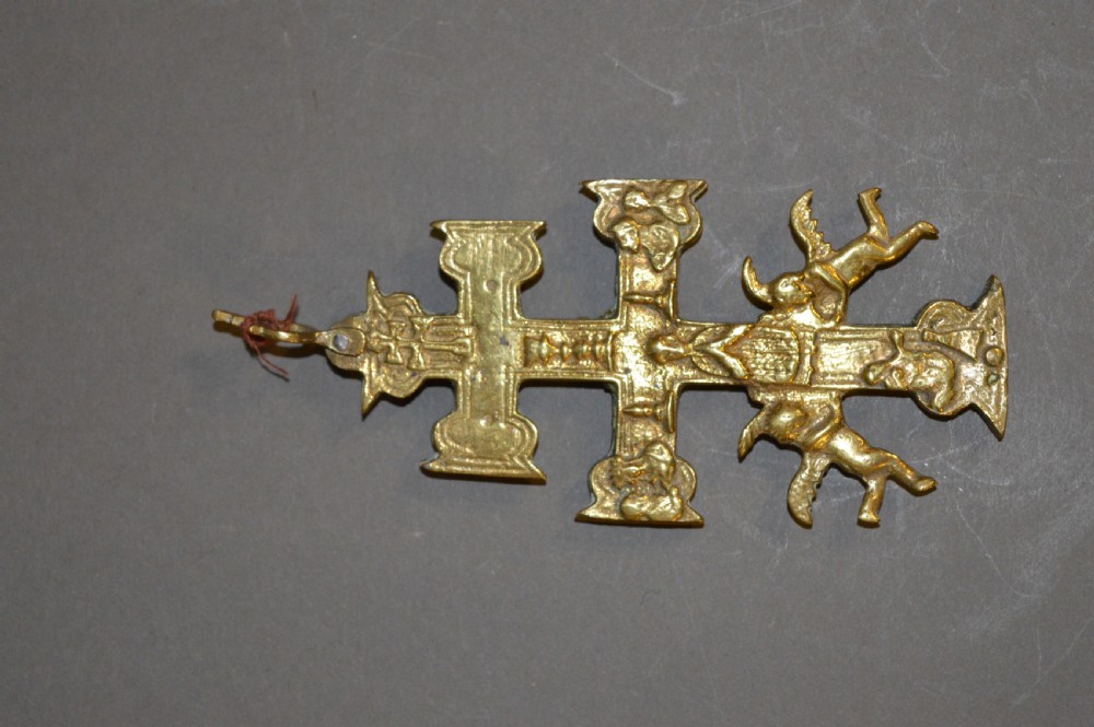 A set of three late nineteenth-century Spanish brass devotional items, including two Caravaca double-barred crosses with angel figures and one central hinged miniature shrine. View VII
