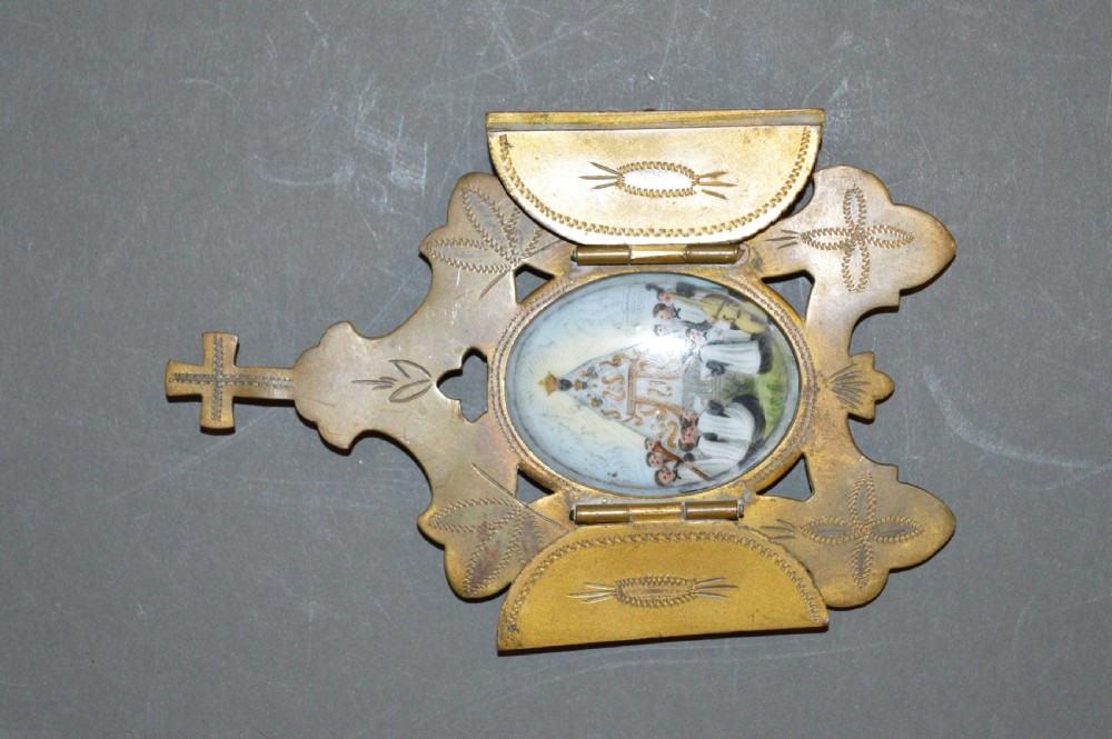 A set of three late nineteenth-century Spanish brass devotional items, including two Caravaca double-barred crosses with angel figures and one central hinged miniature shrine. View VIII