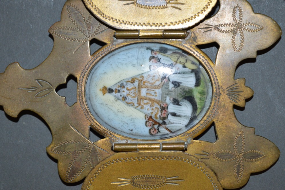 A set of three late nineteenth-century Spanish brass devotional items, including two Caravaca double-barred crosses with angel figures and one central hinged miniature shrine. View IX