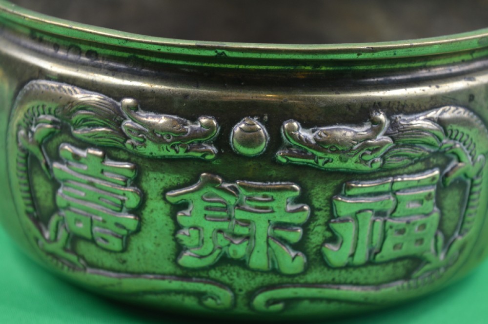 A late 19th-century Chinese cast bronze incense censer featuring raised relief Chinese character panels and side handles formed as lion masks. View II
