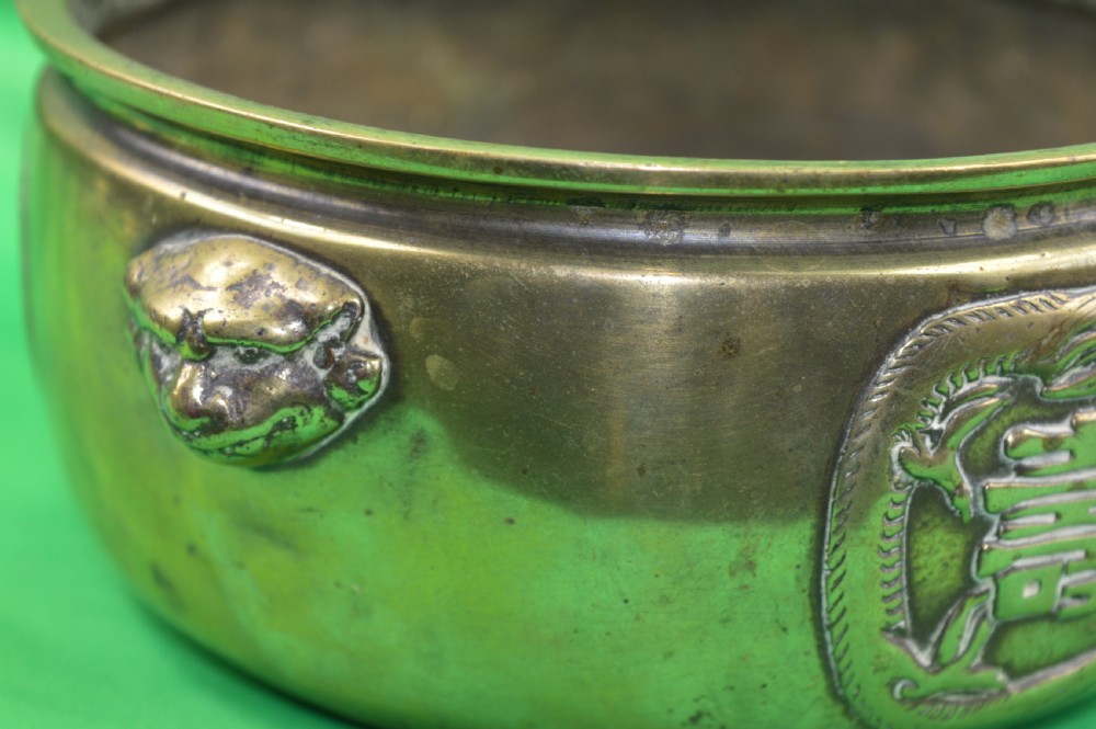 A late 19th-century Chinese cast bronze incense censer featuring raised relief Chinese character panels and side handles formed as lion masks. View III