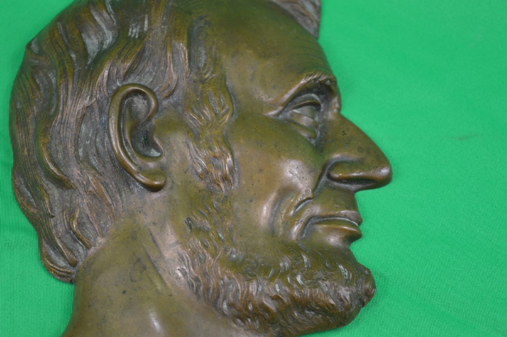 A cast bronze relief profile plaque depicting Abraham Lincoln in right-facing profile with a patinated dark brown surface. View IV