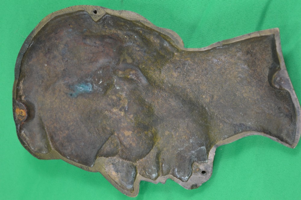A cast bronze relief profile plaque depicting Abraham Lincoln in right-facing profile with a patinated dark brown surface. View V