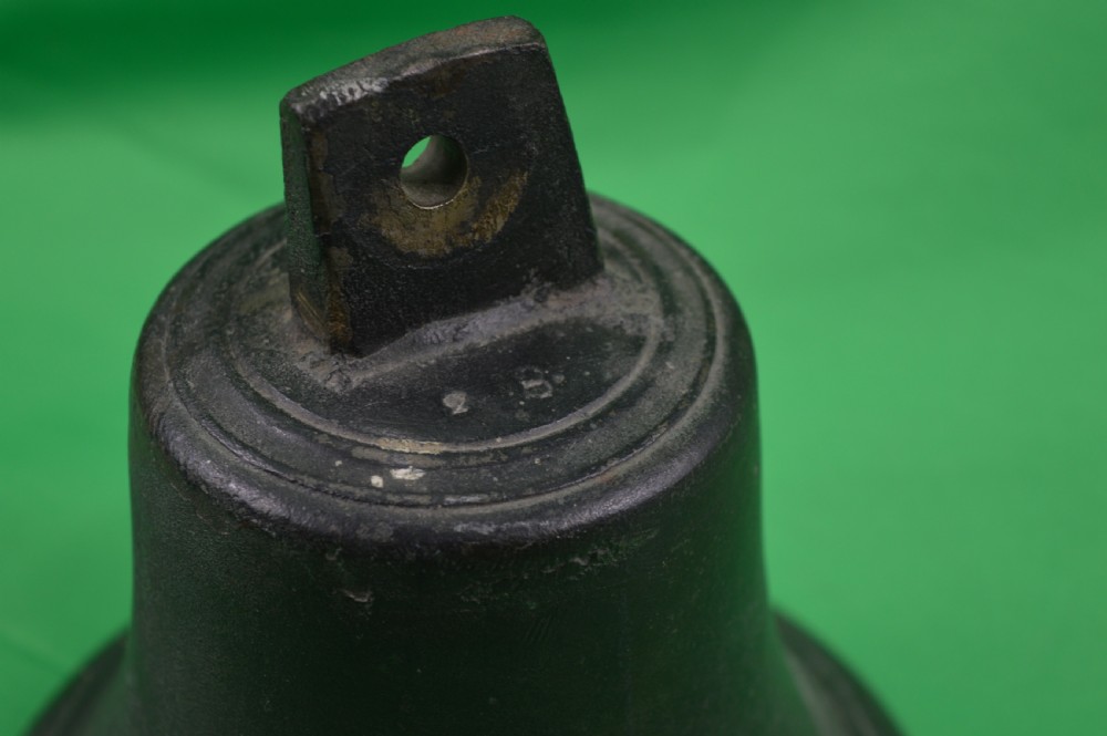 A nineteenth-century cast bronze ships bell featuring a dark aged patina, subtle molded body ring detailing, and an upper mounting lug. View II